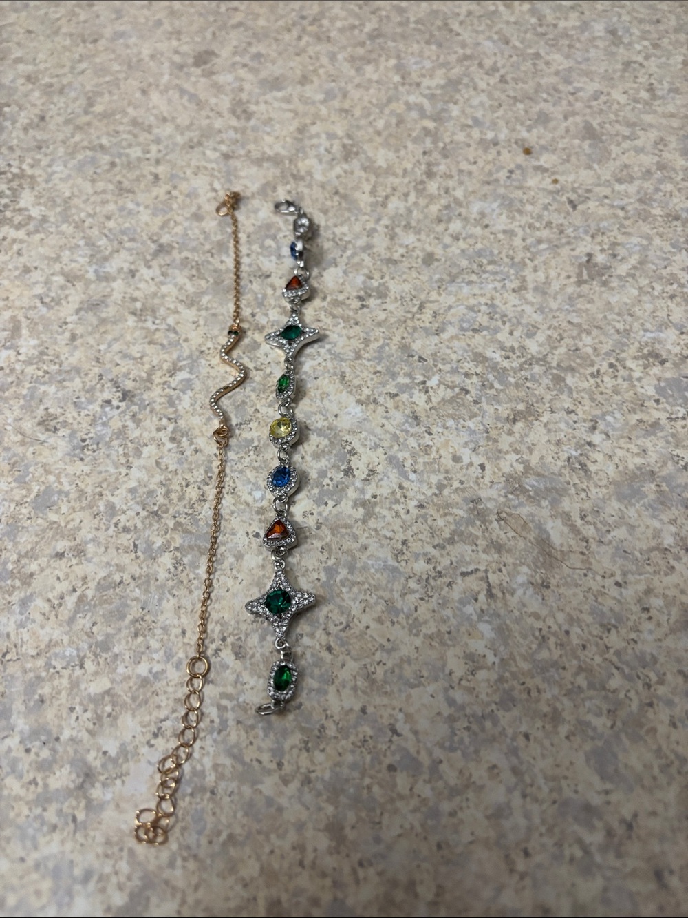 2 bracelets. One gold tone and one silver tone